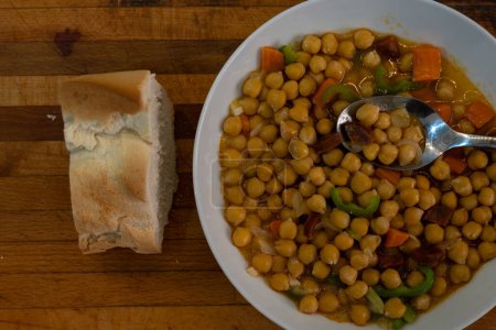 Chickpeas dish with bread for lunch on a wooden table