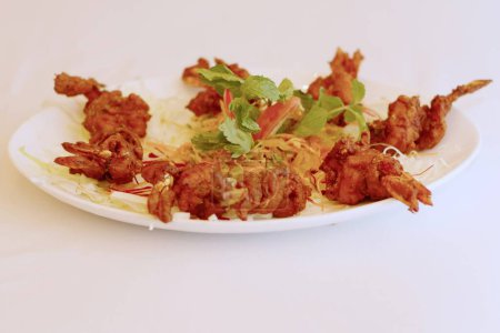 Crispy Masala Marvel": Dive into a world of flavour with these golden-brown Deep-Fried Prawns, expertly marinated in a masala blend, promising a crispy exterior and succulent bite that's sure to tantalise your taste buds.