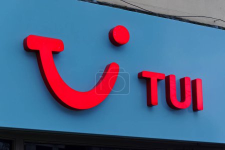 Photo for Cardiff, Wales, UK - December 6 2023: An illuminated TUI Holiday Store Sign in Queen Street, Cardiff, Wales, United Kingdom - Royalty Free Image