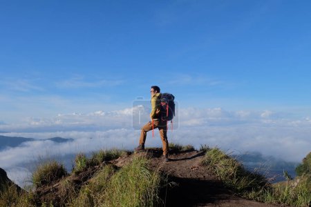 Photo for Peak Paradise, Asian Model on Mount Batur Summit with Ocean of Clouds under Azure Sky - Royalty Free Image
