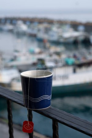 Photo for Morning Close-Up Tea in Mug, Sunrise Bokeh Overlooking Harbour Views in Taiwan - Royalty Free Image