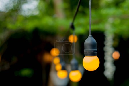Photo for Lights on an outdoor cafe on a bokeh background, selective focus - Royalty Free Image