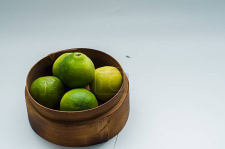 Téléchargez les photos : Lime sur un mini panier en bambou - en image libre de droit
