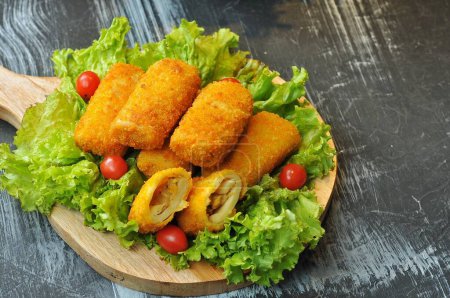 Photo for Risoles served on lettuce leaves and a wooden base - Royalty Free Image
