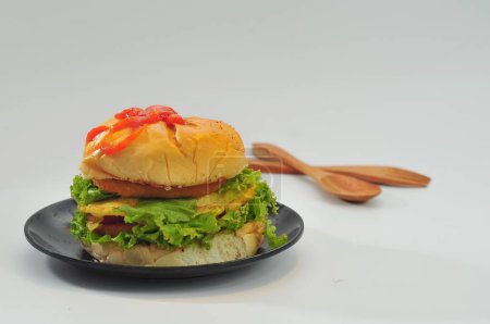 Photo for Burger with chicken, lettuce, blur background - Royalty Free Image