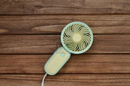 portable fan on wood table