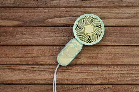 Photo for Portable fan on wood table - Royalty Free Image