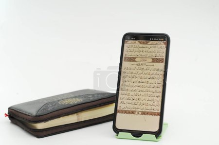 Téléchargez les photos : Le Coran sous forme numérique sur votre téléphone portable - en image libre de droit