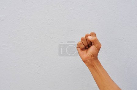 Photo for Male fist in front of gray background. - Royalty Free Image