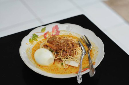 Photo for Lontong is a food made from rice wrapped in banana leaves and then boiled. This food is often considered another form of rice and can be paired with various side dishes - Royalty Free Image