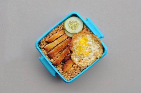 Photo for Fried rice with frid egg, nuggets, cucumber on table - Royalty Free Image