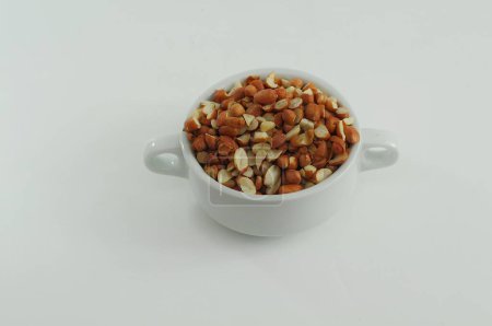 Photo for Chopped raw peanuts in a white bowl - Royalty Free Image