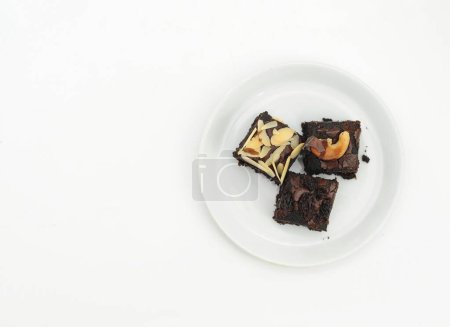 Photo for Chocolate brownies with cream on a white plate - Royalty Free Image