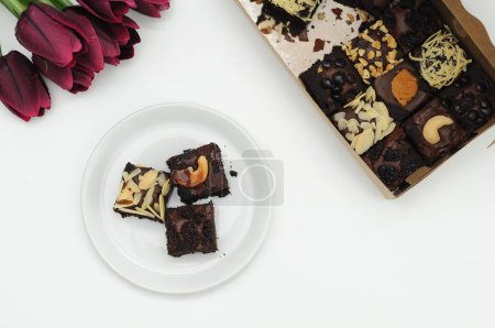 Photo for Sweet chocolate cake with nuts and flowers - Royalty Free Image