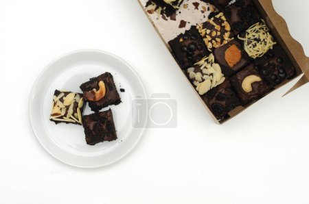 Photo for Chocolate brownies with white chocolate topping on white background - Royalty Free Image