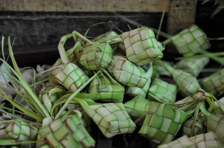 Ketupat (in Indonesian and Malay), or kupat (in Javanese and Sundanese), or tipat (in Balinese) is a Javanese rice cake packed inside a diamond-shaped container of woven palm leaf pouch,
