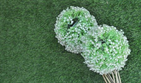 artificial flowers on synthetic grass