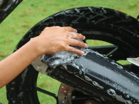 Wash a dirty motorbike using soapy water