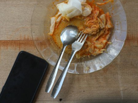 The rest of the plate of lontong with coconut milk sauce