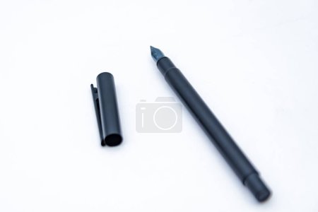 black pen on white background