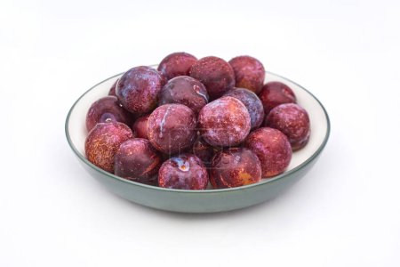 Photo for A plate of plums on a white background - Royalty Free Image