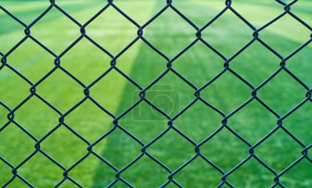 Photo for Barbed wire fence outside a football field - Royalty Free Image