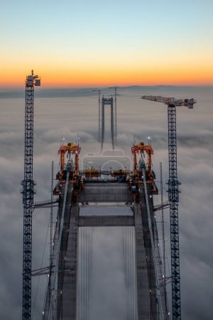 Panoramic aerial drone view from above of the suspended bridge over danube river, under construction, between Braila and Tulcea cities in Romania