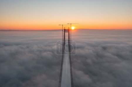 Photo for Panoramic aerial drone view from above of the suspended bridge over danube river, under construction, between Braila and Tulcea cities in Romania - Royalty Free Image