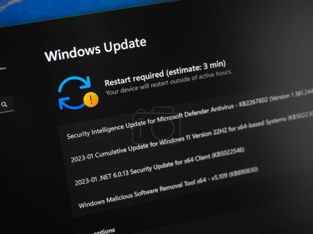 Foto de Galati, Romania - January 20, 2023: Checking for Windows 11 updates on laptop screen close up view. Windows 11 requires restart to update - Imagen libre de derechos