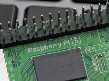 Photo for Galati, ROMANIA - November 10, 2023: Close-up of a Raspberry Pi 5 and GPIO pins port on a laptop keyboard. The Raspberry Pi is a credit-card-sized single-board computer developed in the UK - Royalty Free Image