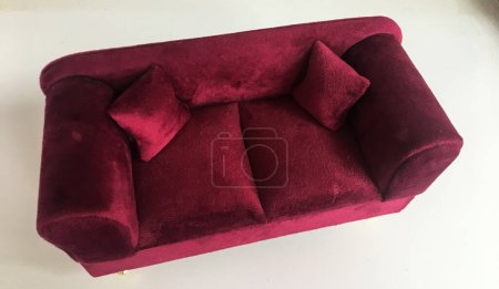 Foto de Un sofá rojo decorativo en miniatura, un sofá de lujo rojo hecho a mano - Imagen libre de derechos