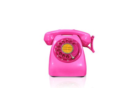 Old fashioned pink desk phone isolated on white background.