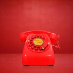 Red vintage telephone on red background