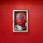 Fire extinguisher for fire protection on red wall