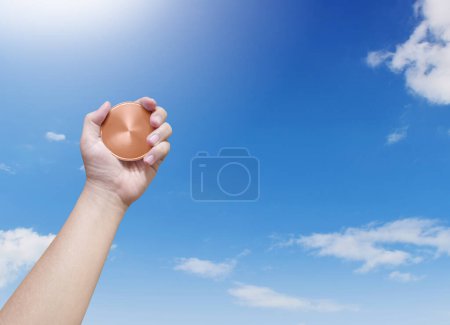 Photo for Holding a bronze coin on the sky background Winner and success concept - Royalty Free Image