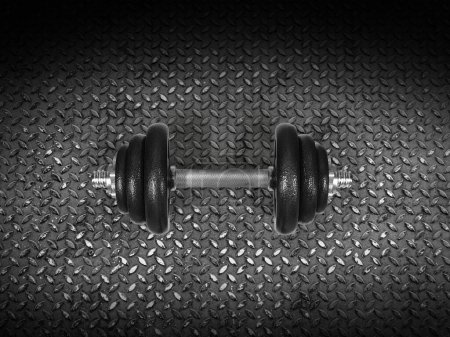 Dumbbells resting on a steel plate, top view