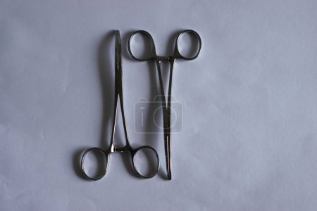 Selective focus of two surgical scissors or forceps on white background