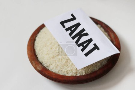 Rice in a wooden bowl on a white background.With copy space. Islamic Zakat concept.special during ramadan.