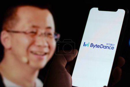 Photo for Indonesia - March,18th 2024: Hand holding smartphone With The ByteDance logo is displayed on a smartphone screen with CEO Zhang Yiming in background - Royalty Free Image