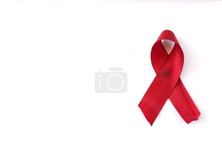 Téléchargez les photos : Ruban rouge sur chemise blanche, symbole de prévention de la toxicomanie, solidarité des personnes vivant avec le VIH luttant contre le sida. Journée mondiale du sida. Concept de promotion du bilan de santé. - en image libre de droit
