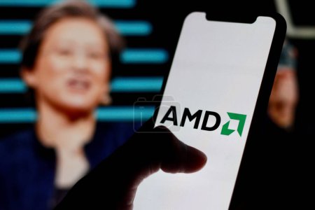 Photo for Indonesia - March 30th 2024: AMD logo is displayed on smartphone screen with CEO Lisa Su in background. - Royalty Free Image