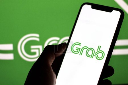 Photo for Indonesia - April 2,2024: Grab logo is displayed on a smartphone screen. - Royalty Free Image