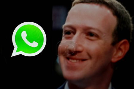 Photo for Indonesia - April 2,2024: WhatsApp mobile app on a screen smartphone iPhone closeup. WhatsApp is a popular free instant text messaging system With Mark Zuckerberg in background. - Royalty Free Image