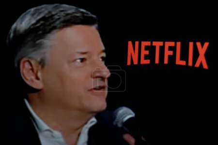 Photo for Indonesia - April 16th 2024: Logo of Netflix is displayed on a smartphone screen with CEO Ted Sarandos in the background. - Royalty Free Image