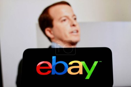 Photo for Indonesia - April 16th 2024: Logo of Ebay is displayed on a smartphone screen with CEO Jamie Iannone in the background - Royalty Free Image