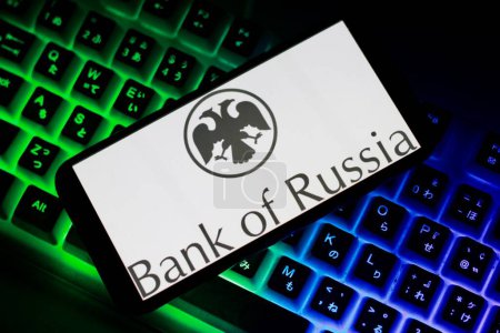 Foto de The logo of Bank Of Rusia,BOR, is displayed on smartphone screen.indonesia-April 23th 2024. Computer keyboard on background - Imagen libre de derechos