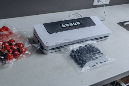 fresh berries in a vacuum bag with a vacuumiser machine. High quality photo