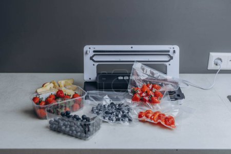 Photo for Fresh berries in a vacuum bag with a vacuumiser machine. High quality photo - Royalty Free Image