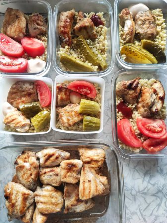 portioned food, cooking for the week, food containers, grilled chicken, vegetables, cooking process,