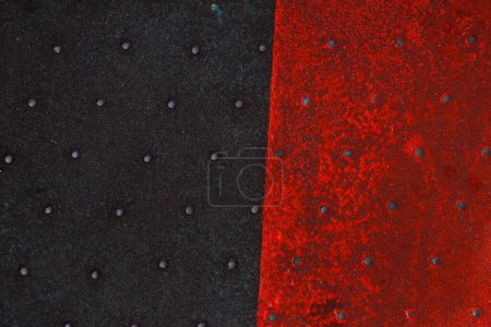 Photo for Grunge steel industrial boat floor plate painted red black anti-rust paint. Robust ferry ship metal pattern. Old dotted iron deck. Worn metal texture background. Modern design concept. Copy space - Royalty Free Image